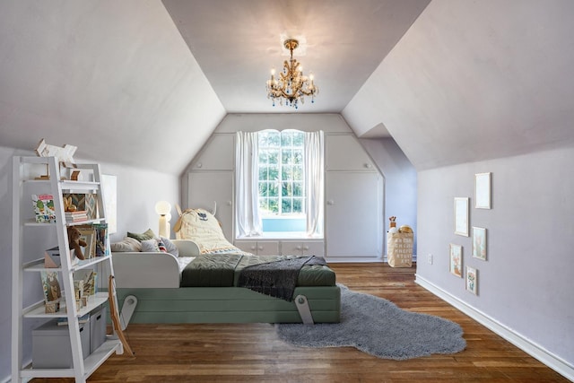 bedroom featuring hardwood / wood-style floors, an inviting chandelier, and vaulted ceiling