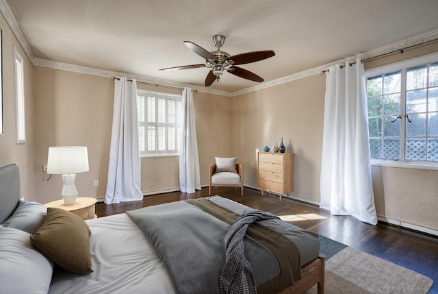 bedroom featuring ceiling fan, dark hardwood / wood-style flooring, and crown molding