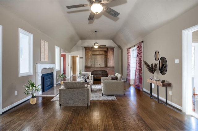 living room featuring ceiling fan, dark hardwood / wood-style floors, and vaulted ceiling