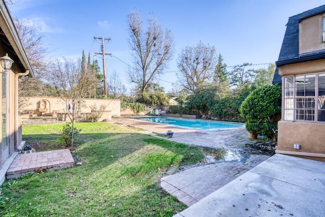 view of yard featuring a patio area and a fenced in pool