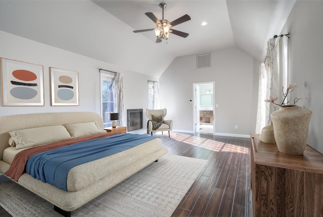 bedroom with hardwood / wood-style flooring, ensuite bath, ceiling fan, and lofted ceiling