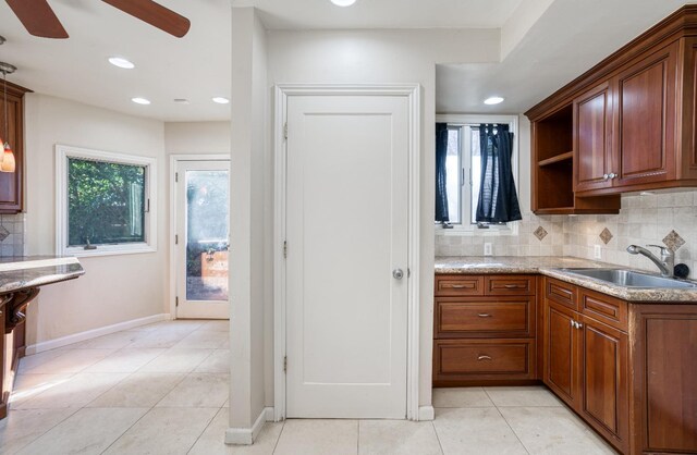 3628 N Van Ness, Fresno, CA 93704 - kitchen featuring ceiling fan, decorative backsplash, light tile patterned floors, light stone counters, and recessed lighting