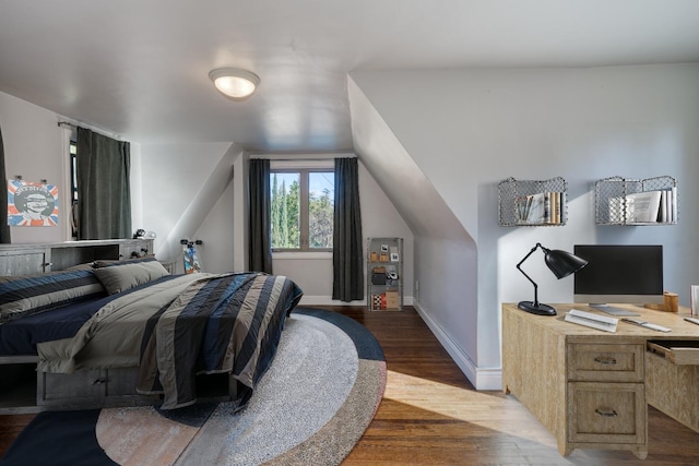 bedroom with hardwood / wood-style flooring and lofted ceiling