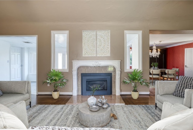 living room with a notable chandelier, dark hardwood / wood-style floors, and a tile fireplace