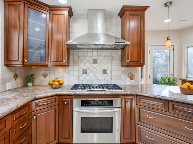 3628 N Van Ness, Fresno, CA 93704 - kitchen with wall chimney exhaust hood, stainless steel appliances, brown cabinets, and decorative backsplash