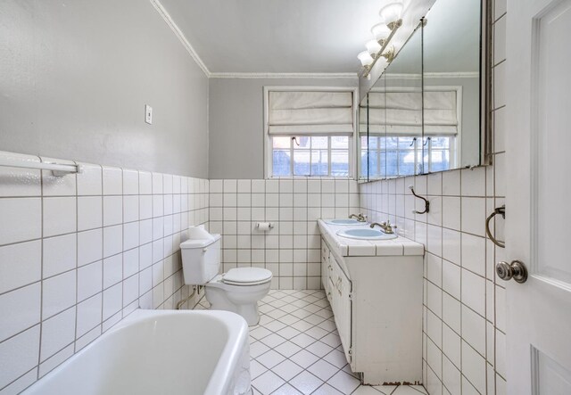 3628 N Van Ness, Fresno, CA 93704 - bathroom featuring tile walls, a tub, crown molding, vanity, and tile patterned flooring