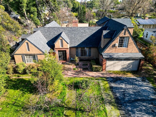 3628 N Van Ness, Fresno, CA 93704 - tudor home with roof with shingles, driveway, a chimney, french doors, and brick siding