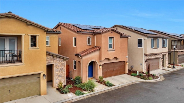 view of front of home with solar panels and a garage