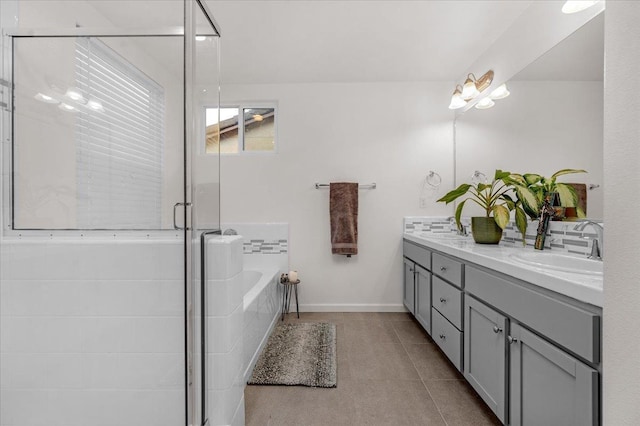 bathroom featuring tile patterned floors, plus walk in shower, and vanity