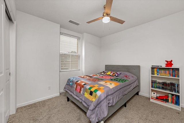 bedroom with ceiling fan and light carpet