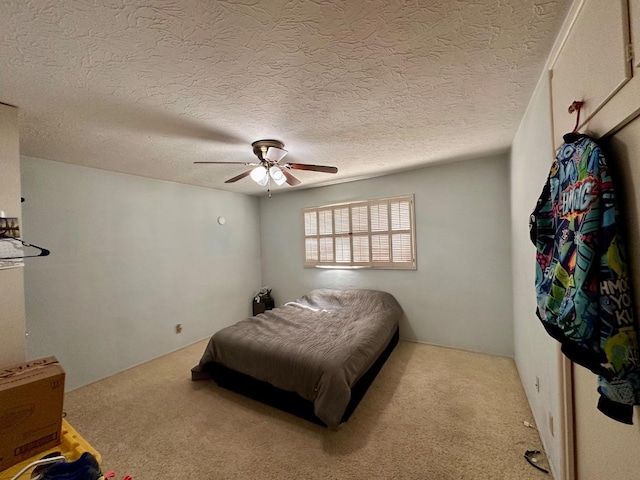 carpeted bedroom featuring ceiling fan and a textured ceiling