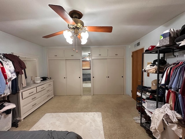 bedroom featuring multiple closets and ceiling fan