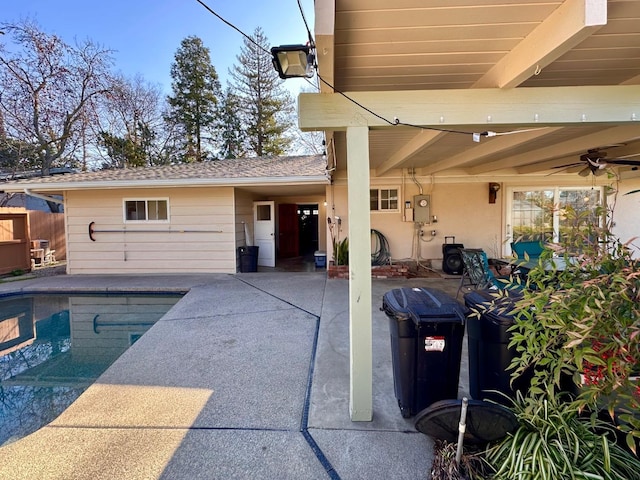 view of pool with ceiling fan and a patio