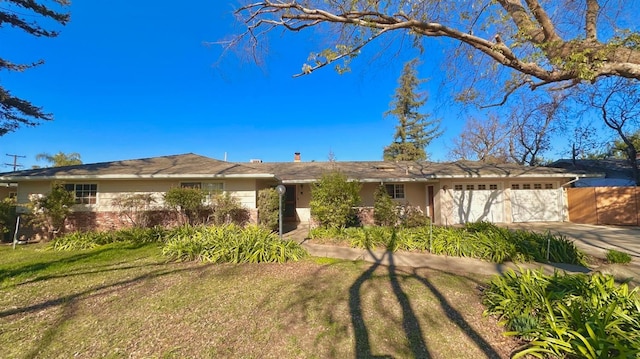 single story home with a garage and a front lawn