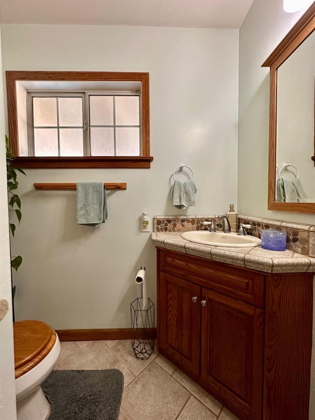 bathroom with tile patterned floors, vanity, and toilet