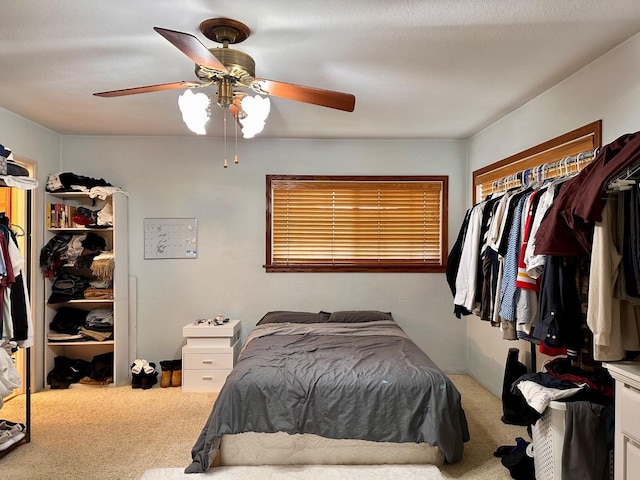 bedroom with ceiling fan and carpet flooring