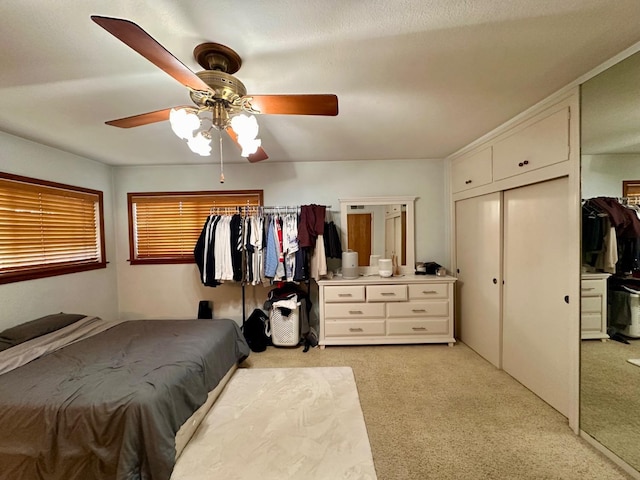 bedroom with light colored carpet and ceiling fan