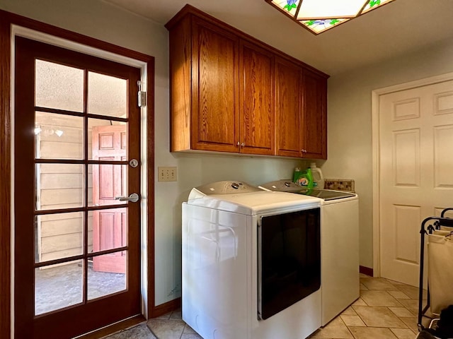 laundry room featuring separate washer and dryer and cabinets