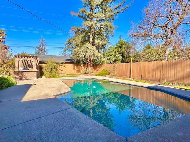 view of swimming pool with an outdoor kitchen