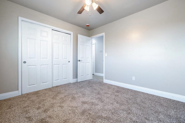 unfurnished bedroom with carpet, a closet, and ceiling fan