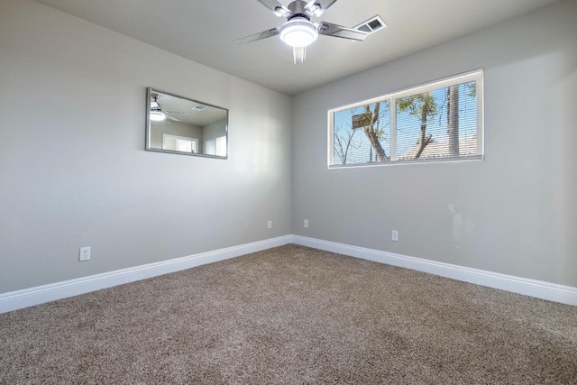 carpeted spare room featuring ceiling fan