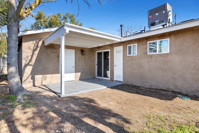 rear view of property featuring a patio area and central air condition unit