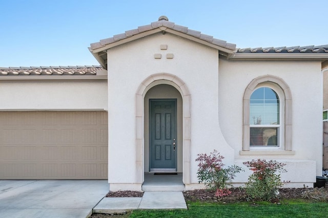 doorway to property with a garage