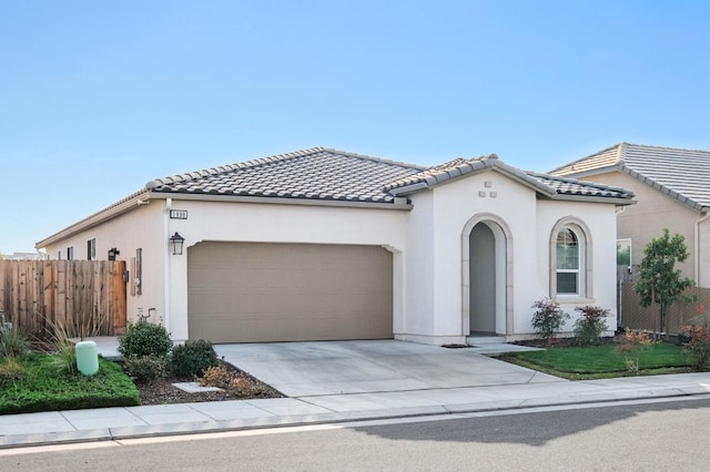 mediterranean / spanish-style home with a garage