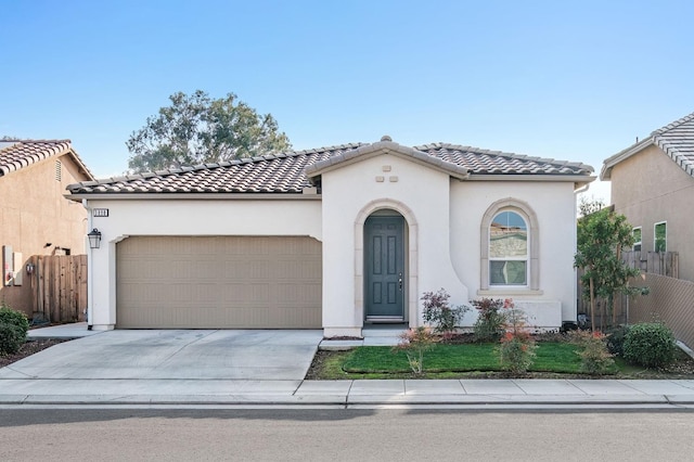 mediterranean / spanish-style home with a garage