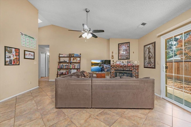 living room featuring a textured ceiling, ceiling fan, a fireplace, and lofted ceiling