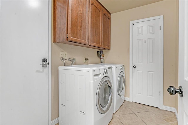 washroom with cabinets, light tile patterned floors, and separate washer and dryer