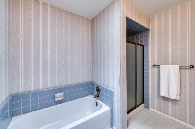 bathroom featuring tile patterned floors and separate shower and tub