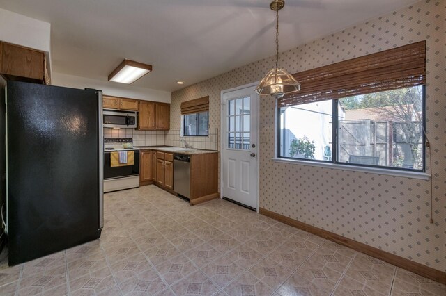 kitchen featuring pendant lighting, stainless steel appliances, and sink