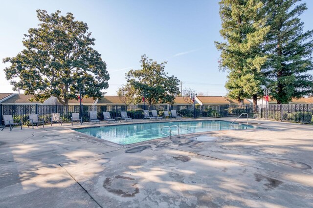 view of swimming pool featuring a patio area