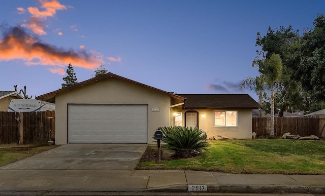 single story home with a lawn and a garage