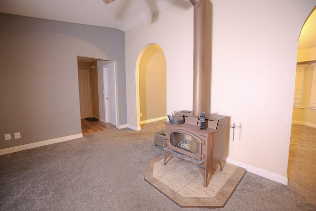 corridor featuring carpet flooring and vaulted ceiling