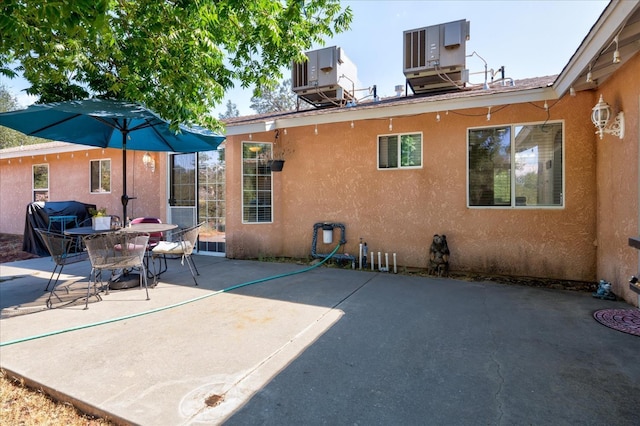 rear view of house featuring a patio and central AC