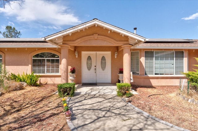 view of front of property featuring solar panels