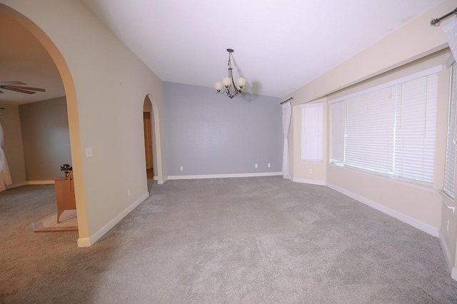 spare room featuring light carpet and ceiling fan with notable chandelier