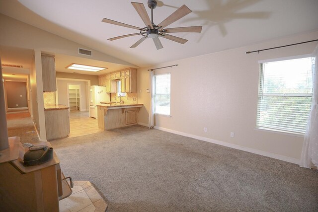 unfurnished living room with light colored carpet, ceiling fan, and lofted ceiling