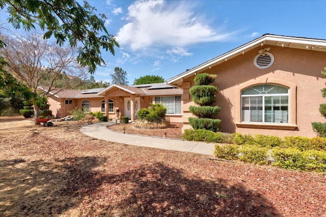 single story home featuring covered porch and solar panels