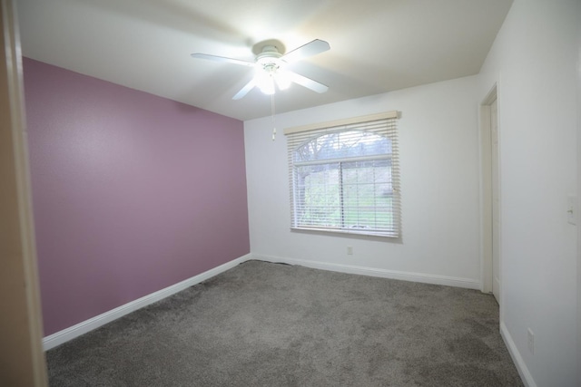 carpeted spare room with ceiling fan