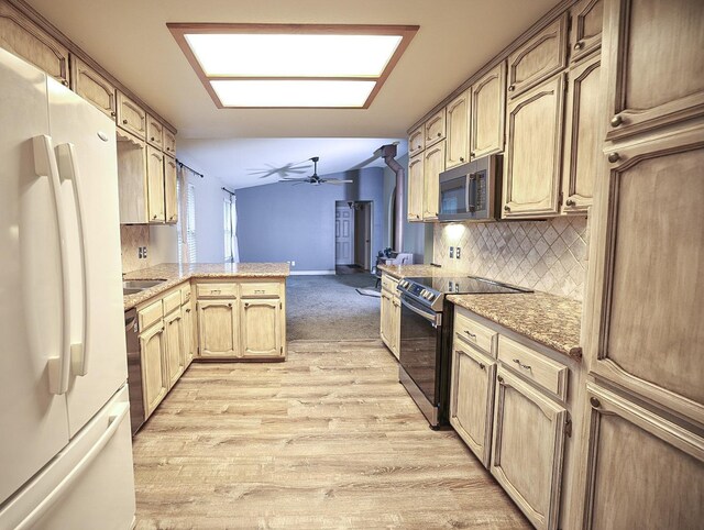 kitchen featuring black electric range oven, white refrigerator, ceiling fan, decorative backsplash, and kitchen peninsula