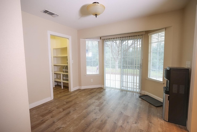 interior space with hardwood / wood-style floors and a healthy amount of sunlight