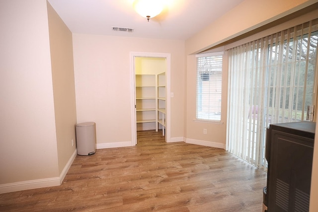 empty room with light hardwood / wood-style floors