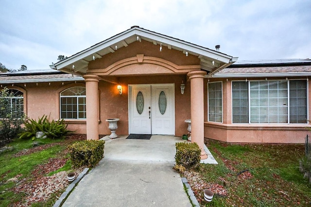 doorway to property featuring solar panels