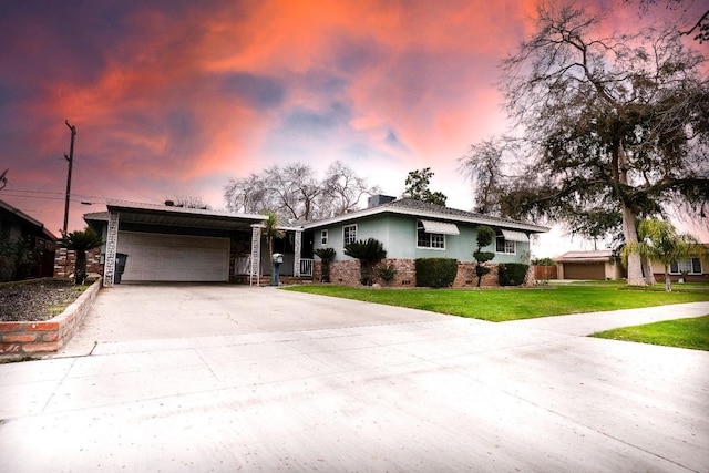 ranch-style house with a garage and a yard