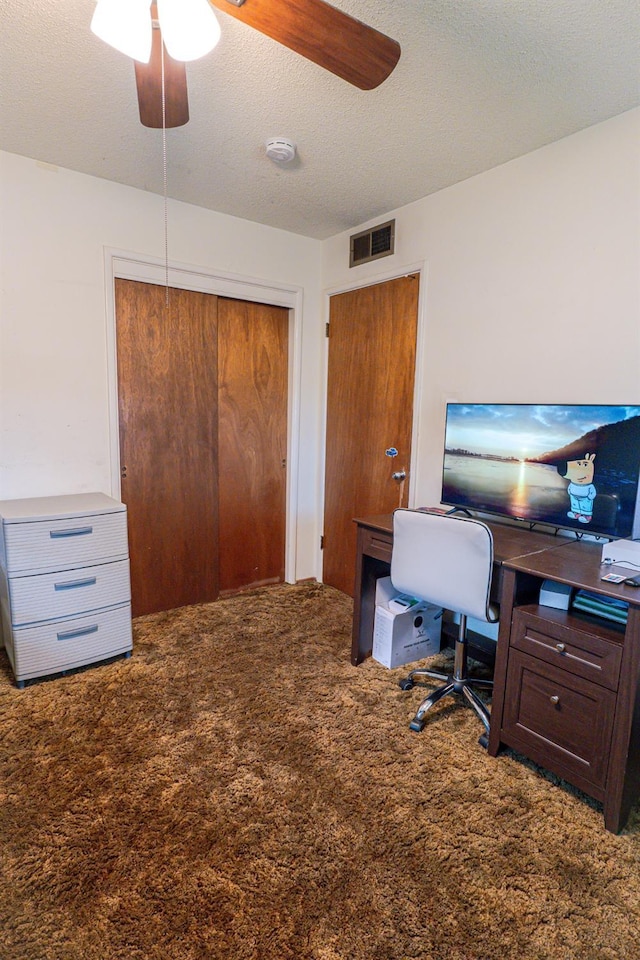 office featuring ceiling fan, carpet, and a textured ceiling