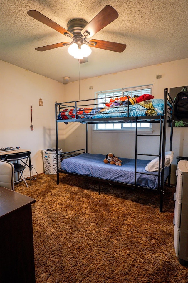 carpeted bedroom featuring a textured ceiling and ceiling fan