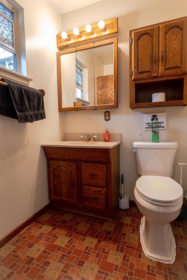 bathroom with toilet and vanity